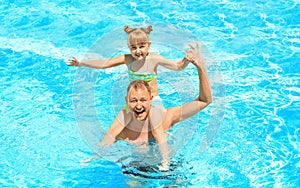 Happy father with daughter resting in swimming pool