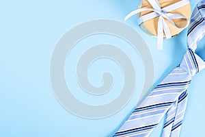 Happy Father Day background concept with blue necktie and gift box on blue background with copy space for text