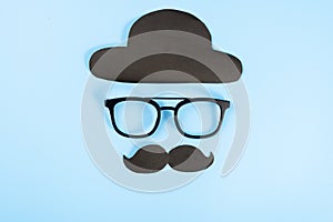 Happy Father Day background concept with glasses, black hat and black mustache on blue background with copy space for text