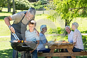 Happy father doing barbecue with his son