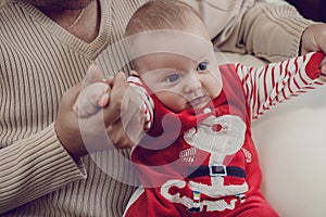 Happy father having fun with newborn baby son, family portrait