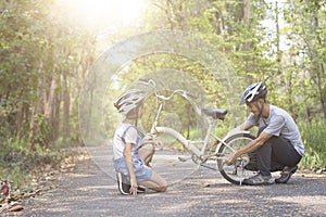 Happy father helped his daughter repair the bike photo