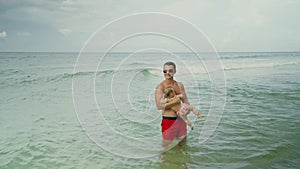 Happy father and his adorable little baby girl at the Panama City Beach having fun