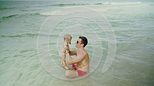 Happy father and his adorable little baby girl at the Panama City Beach having fun