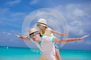 Happy father and his adorable little daughter have fun at tropical beach