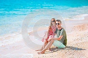 Happy father and his adorable little daughter at tropical beach having fun