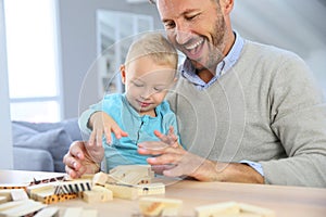 Happy father with his child playing with blocks