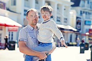 Happy father and his cute little son outdoors