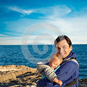 Happy Father with His Little Son in Carrier