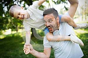 Happy father and his son spending time together and playing, smiling outdoor