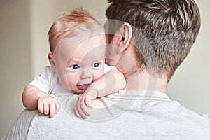 Happy father holding newborn baby in his arms