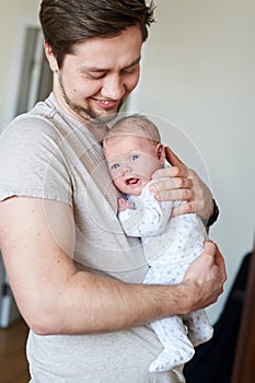 Happy father holding newborn baby in his arms