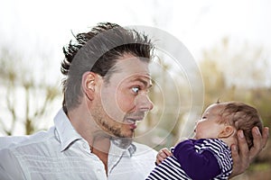 Happy father joking with baby girl photo