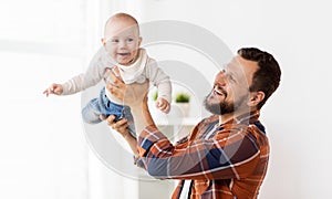 Happy father with little baby boy at home