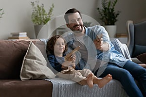 Happy father and little son having fun with toy guns