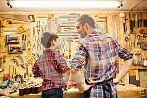 Happy father and little son workshop