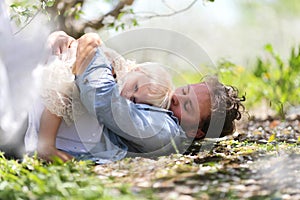 Happy Father Playing with Cute Baby daughter in Autumn Woods