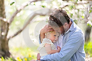 Happy Father Playing with Cute Baby daughter in Autumn Woods