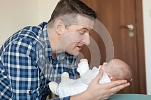 Happy father playing with little baby at home. Family, fatherhood concept photo
