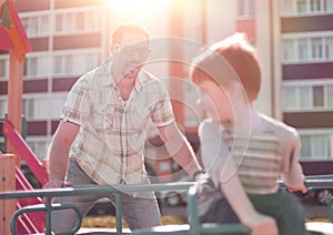 Happy father playing with little boy on the Playground