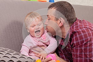 Happy father plays with little daughter, close-up