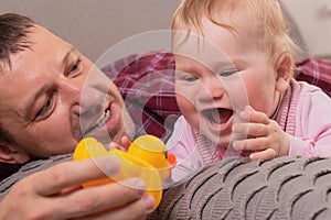 Happy father plays with little daughter, close-up