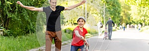 happy father rejoices that her daughter learned to ride a bike