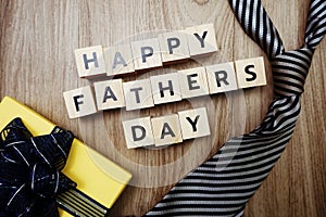 Happy Father`s Day alphabet letters with gift box on wooden background