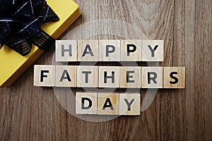 Happy Father`s Day alphabet letters with gift box on wooden background