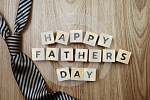 Happy Father`s Day alphabet letters with necktie on wooden background