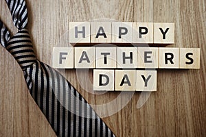 Happy Father`s Day alphabet letters with necktie on wooden background