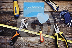 Happy father`s day background concept. Top view of construction handy tools on the wooden background.