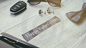 Happy Father`s Day background. Cufflink, car key, bow tie, pen, sunglasses and blue heart.