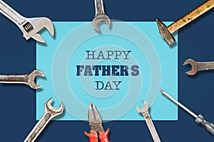 Happy father`s day background. Different tools on dark background Congratulatory background