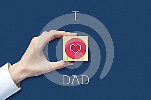 Happy father`s day background. Female hand with social heart icon. Dark background. Congratulatory background