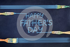 Happy father`s day background. The inscription is painted on a blue background. Paintbrush