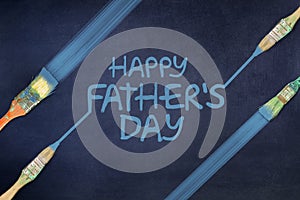 Happy father`s day background. The inscription is painted on a blue background. Paintbrush