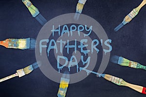 Happy father`s day background. The inscription is painted on a blue background. Paintbrush