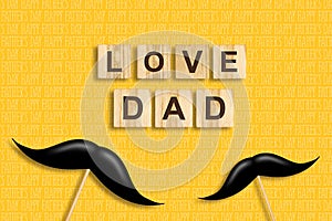 Happy father`s day background. Mustache on a stick. Love Dad, inscription on wooden blocks on a yellow background. Congratulatory
