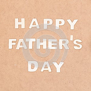 Happy Father`s Day Background. Wooden letters on brown background flat lay. Fathers day.