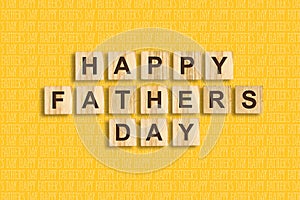Happy father`s day background. Word, written on wooden blocks. Yellow background Congratulatory background