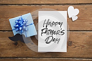 Happy Father's Day card composition with gift box and mustache