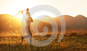 Happy father`s day! Child girl and dad with a kite on nature in