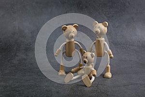 Happy Father`s Day concept. Greeting card with family of wooden toy bears on dark background