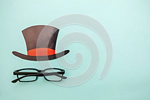 Happy Father`s day concept. Sign of hat with glasses isolated on pastel blue background Man silhouette symbol