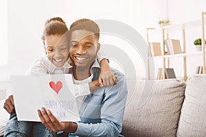 Happy father`s day. Daughter congratulating dad at home