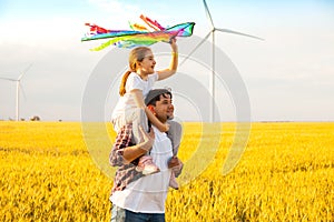 Father and daughter having fun, playing with kite together
