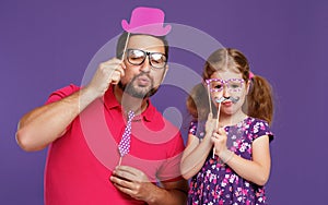 Happy father`s day! funny dad and daughter with mustache fooling