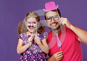 Happy father`s day! funny dad and daughter with mustache fooling