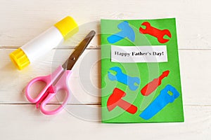 Happy father's day. Greeting card with paper tools. Scissors, glue. Kids paper craft idea. Father's day gift idea